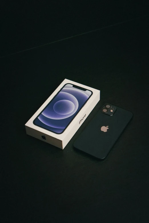 an apple product sits on a dark surface