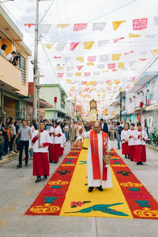 a group of people are walking down a street