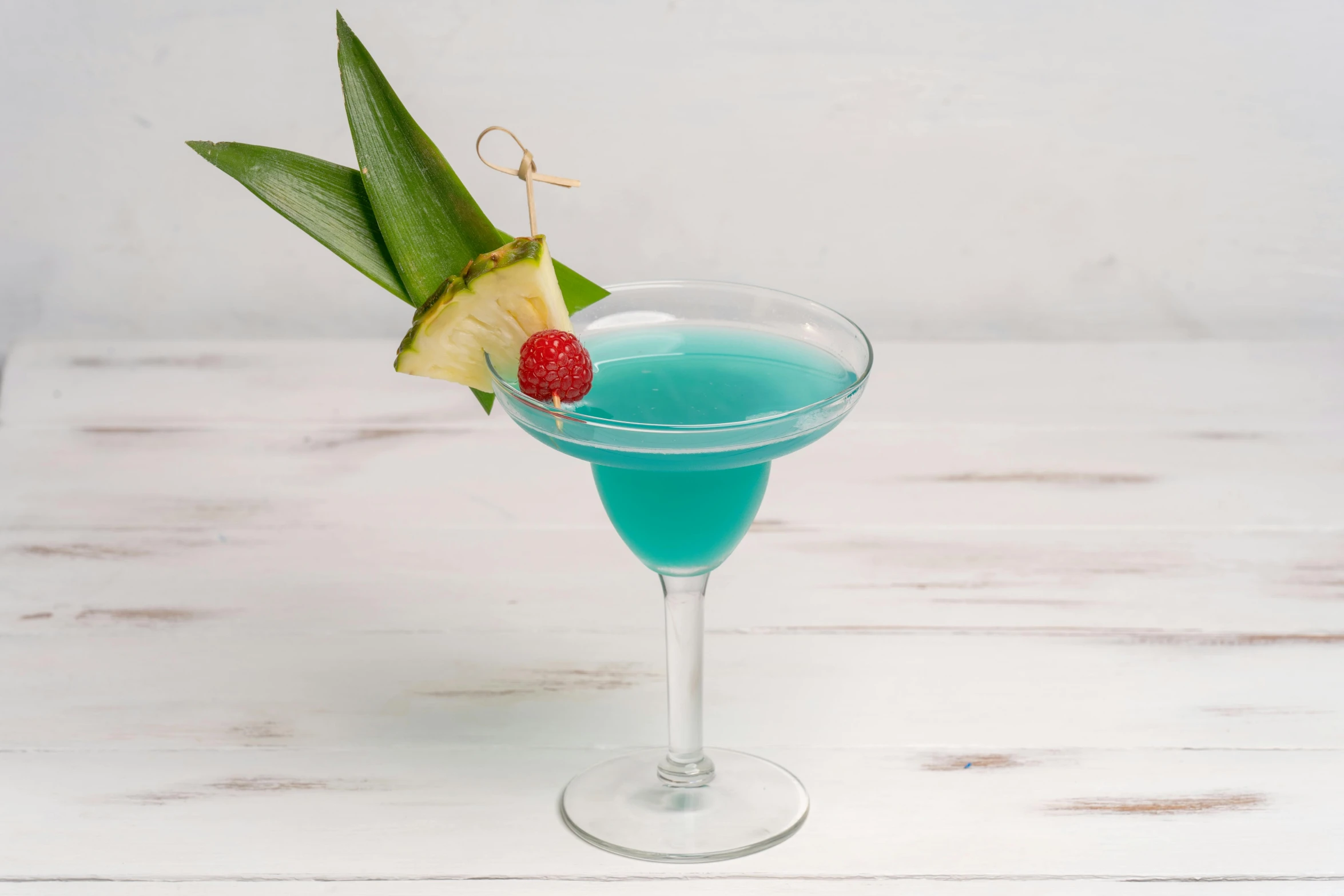 a tropical drink with a small garnish on the rim