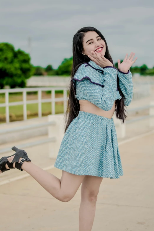 the beautiful woman is smiling and waving at someone