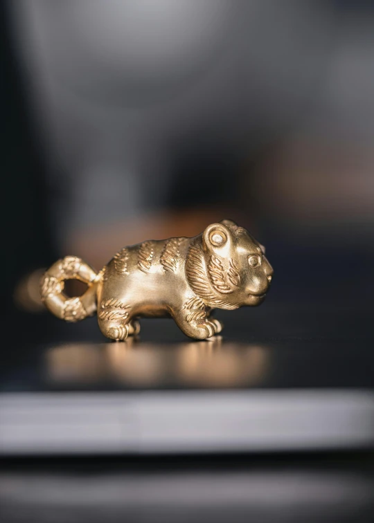 small gold colored figurine of a cat