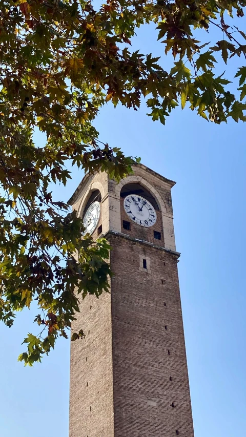 a tall brick tower with a clock on the top of it