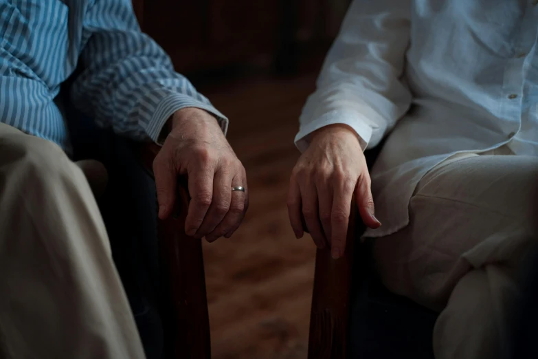 two people sitting in chairs looking toward the camera