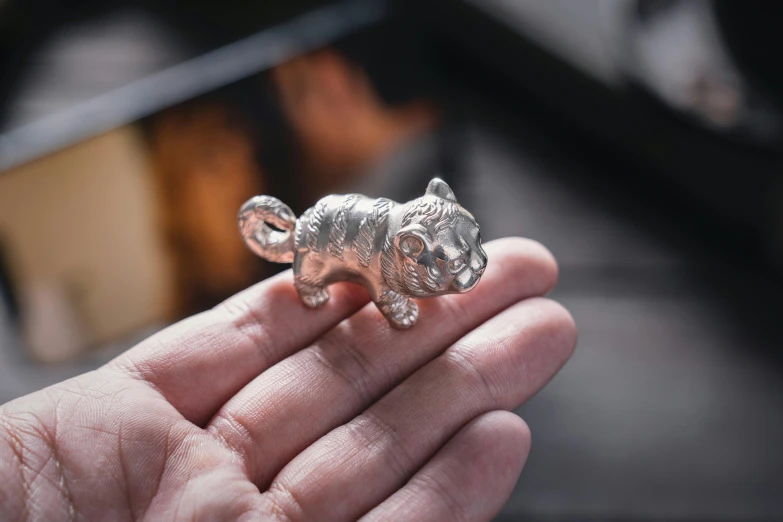 a small toy animal in the palm of someones hand