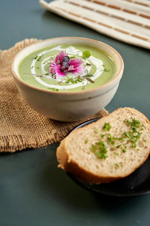 the soup is garnished with an orchid on the side