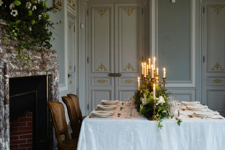 an elegant table sits next to a fireplace in a house