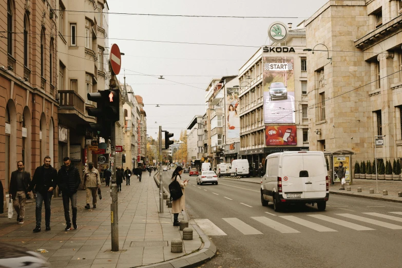 a street with people, cars, and traffic on it