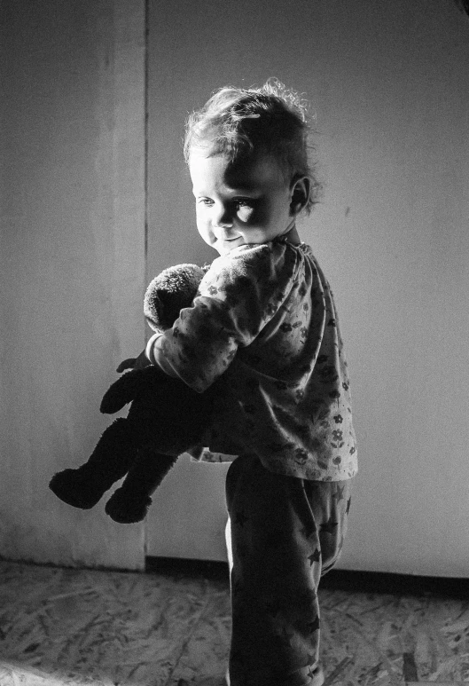 a little boy standing in front of a doorway