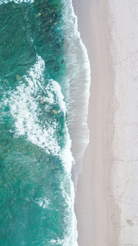 a beach with clear blue water and a shoreline