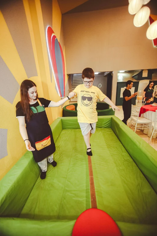 a boy and girl playing with a paddle tennis set