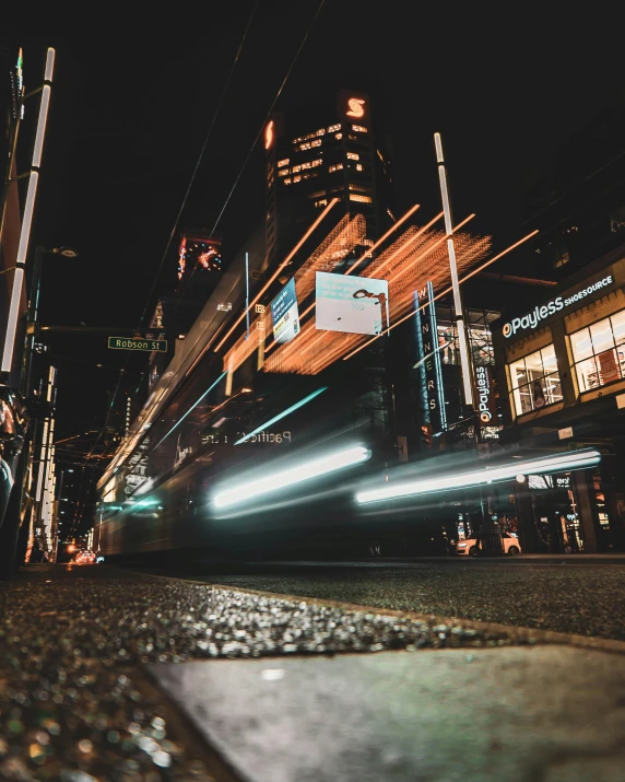 city street at night with moving lights and cars