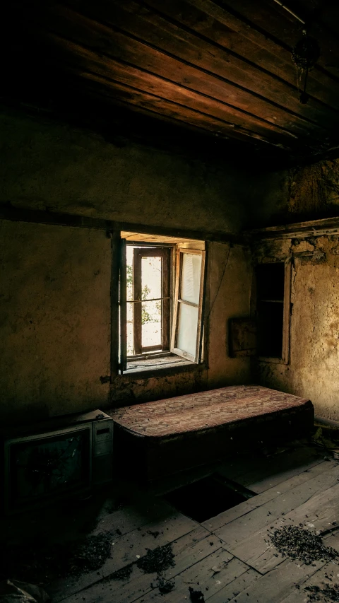 an old room with a mattress and windows