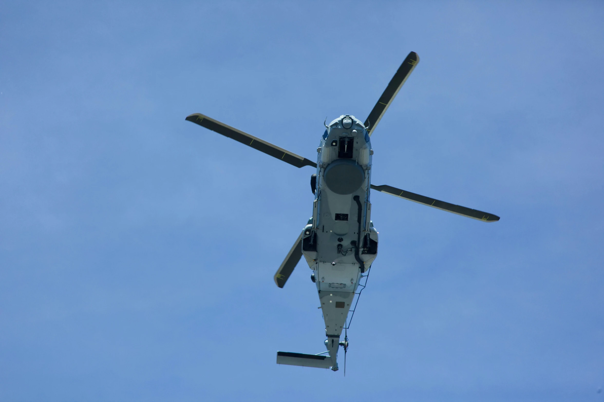 the rear of a helicopter that is flying through the air