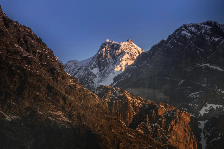 mountain peaks on either side of lake in the sunlight