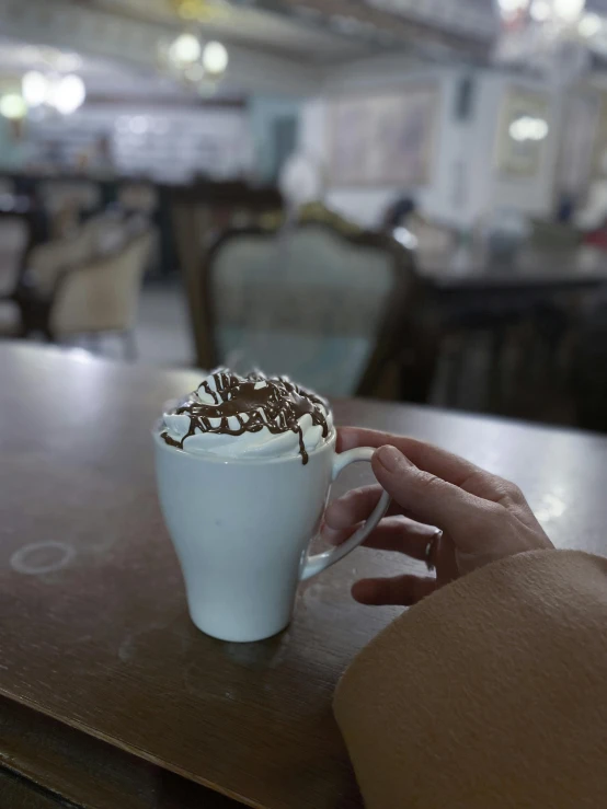 a person holding onto the top of a glass