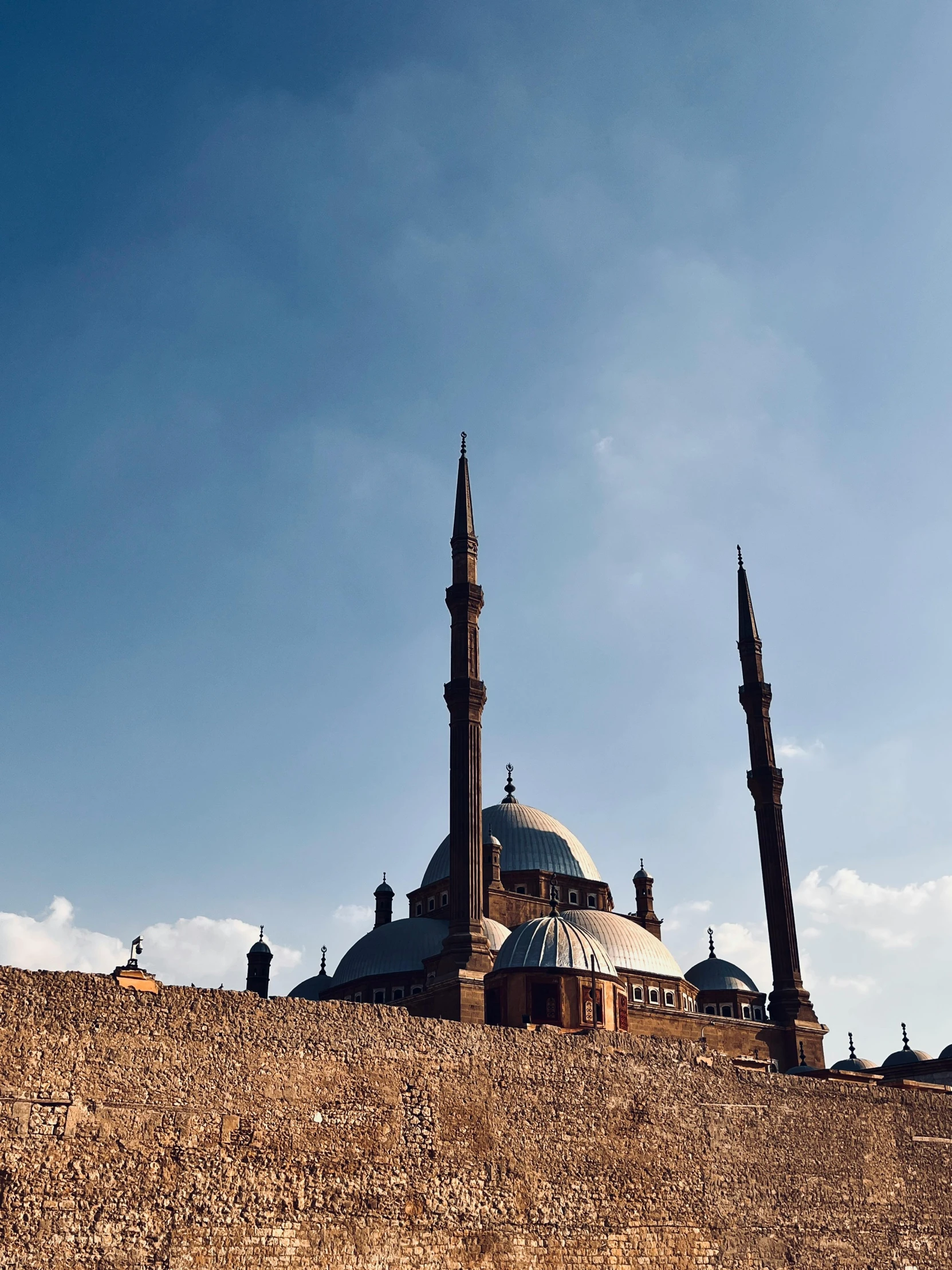 a dome with pillars on top against a blue sky