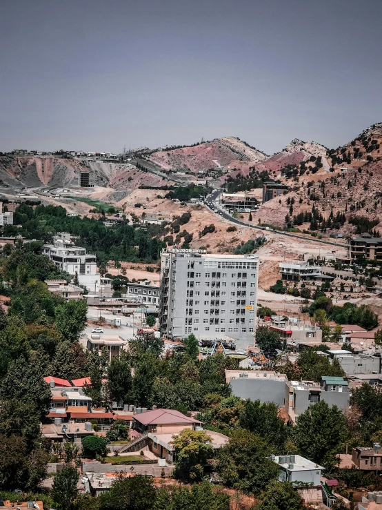 a hill side view with many houses in the distance