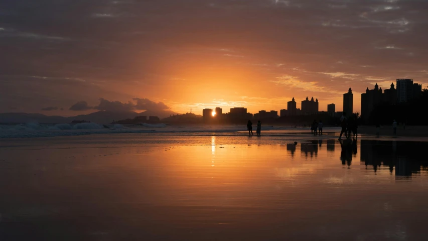 a city at sunset reflecting on the water