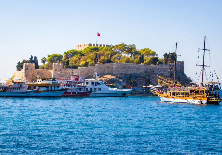 an island with many ships in the water