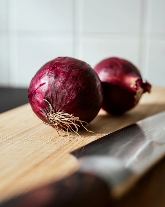 two onions are on top of a  board