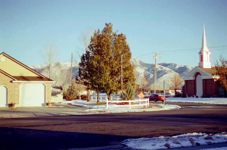 an old style church in front of a church with snowy mountain background