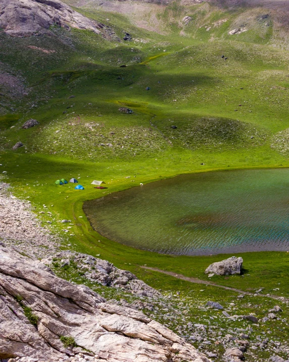 small pond in rocky area with some rocks