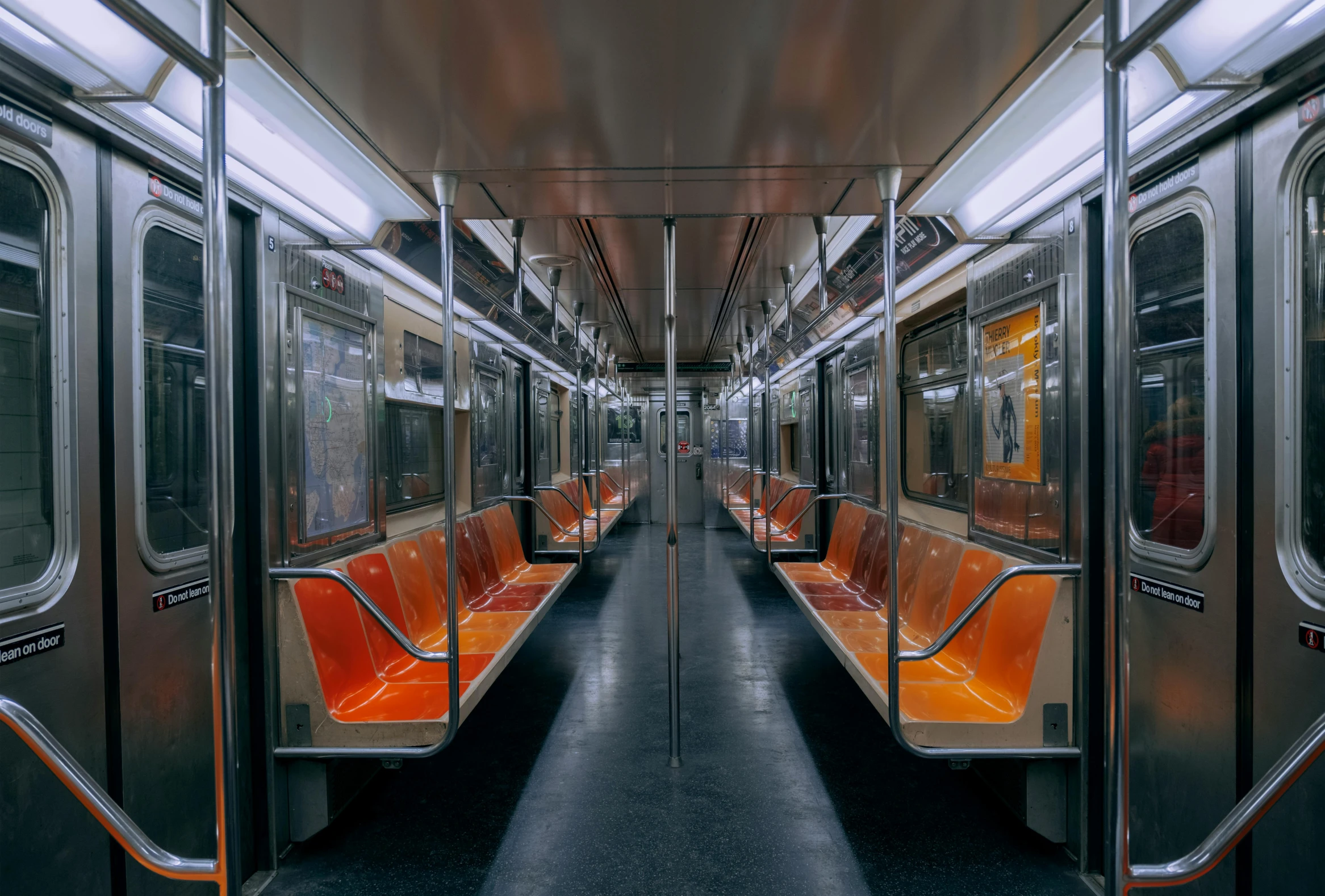 a row of seats that have orange trim