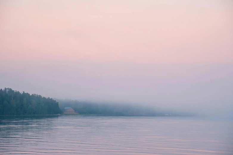 a boat floating on top of a lake near trees