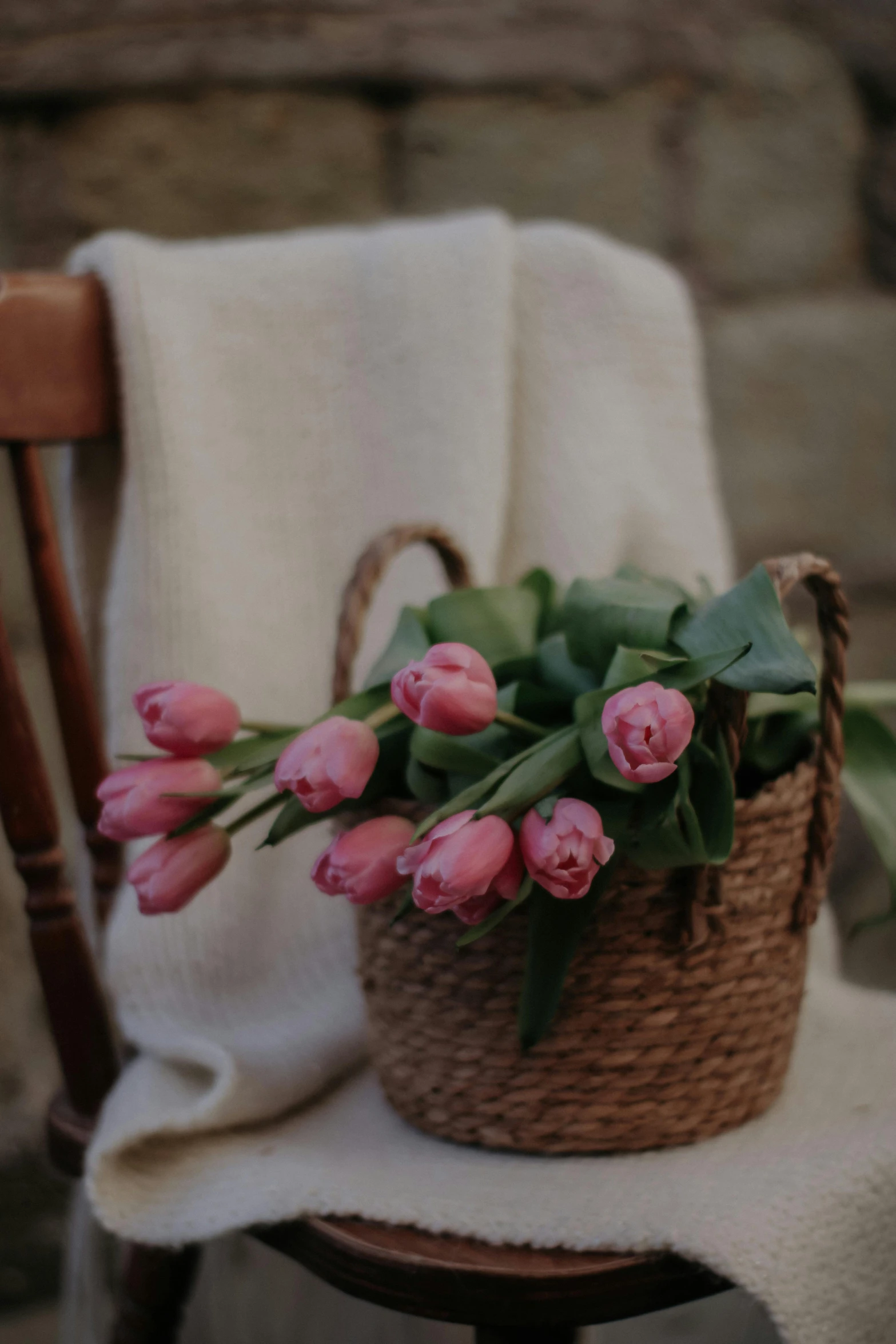 some pink flowers are sitting on top of a chair