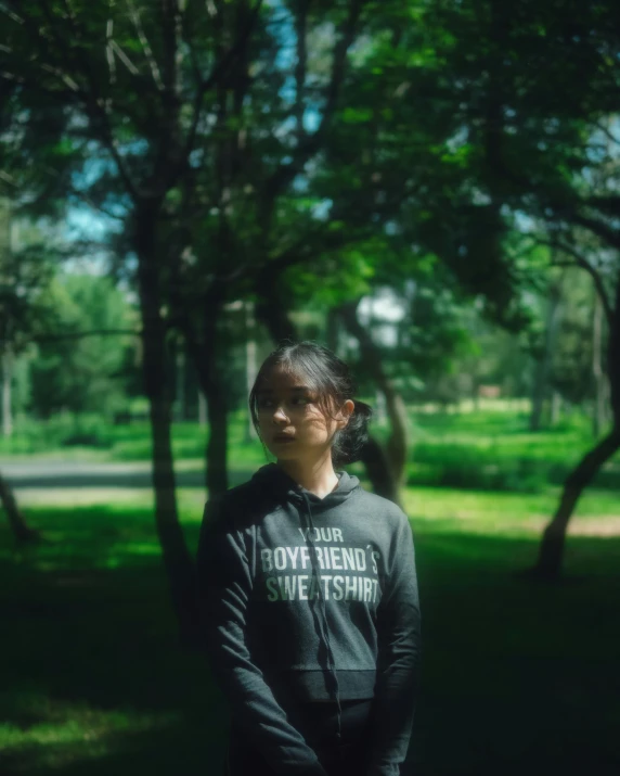 a woman standing in the middle of a green field