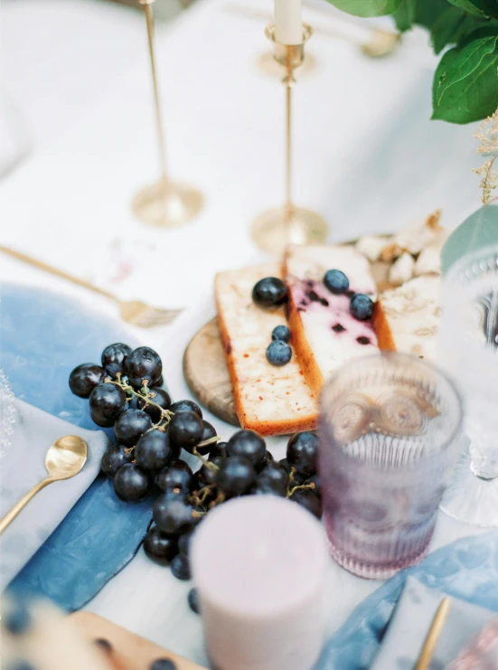 an arrangement of fruits and cheese is on a table