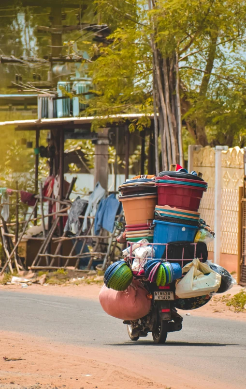 the motorcycle with many bags on back drives down the road