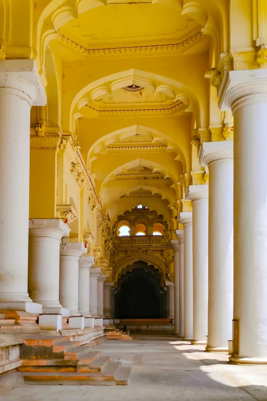 large white pillars line the ceiling of an elaborately decorated building