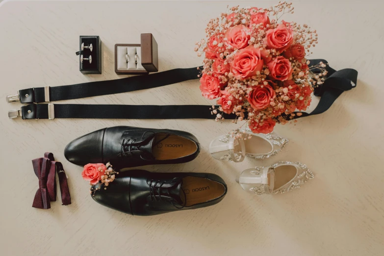 the bouquet of flowers and shoes are ready to be put on