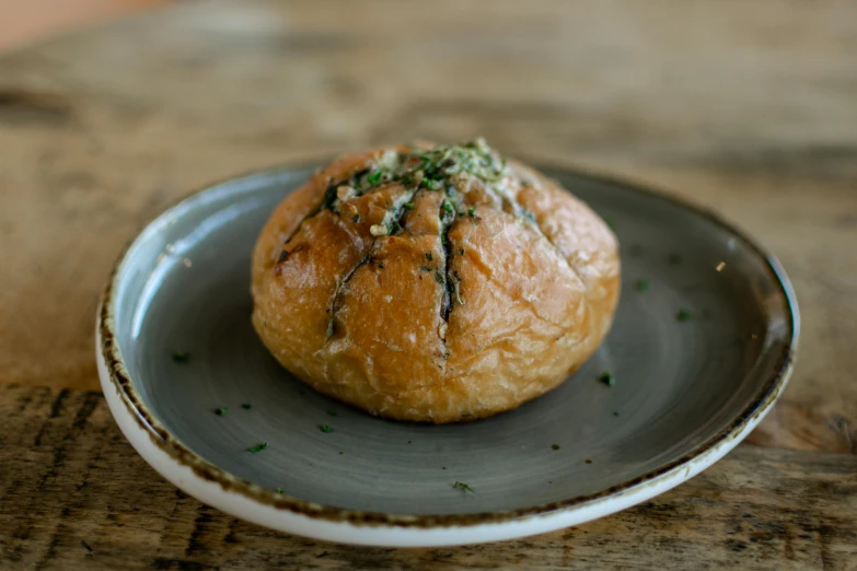 two breads are sitting on a blue plate