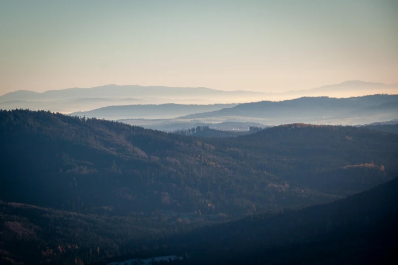 view of a valley surrounded by mountains and valleys