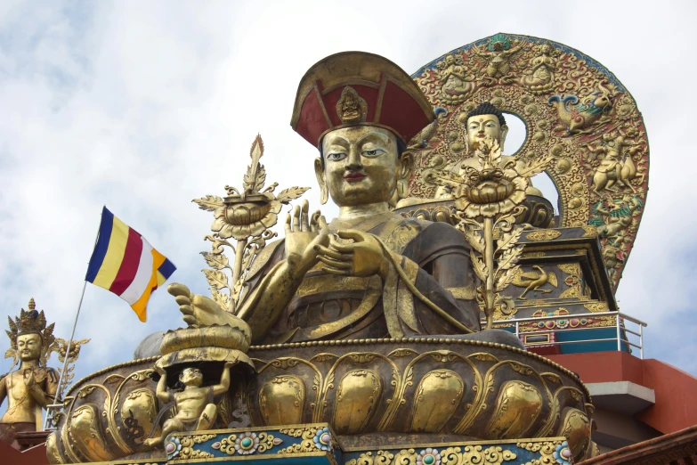 the golden statue has many other buddha's around it