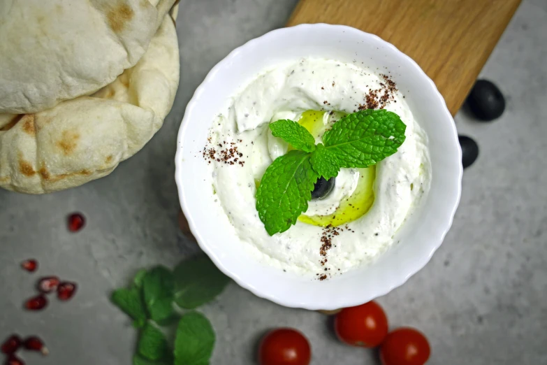 a white bowl filled with soing green and topped with sliced lime