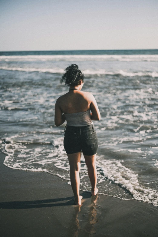 a girl running on a beach near the ocean