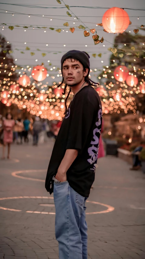 a young man is standing on the street