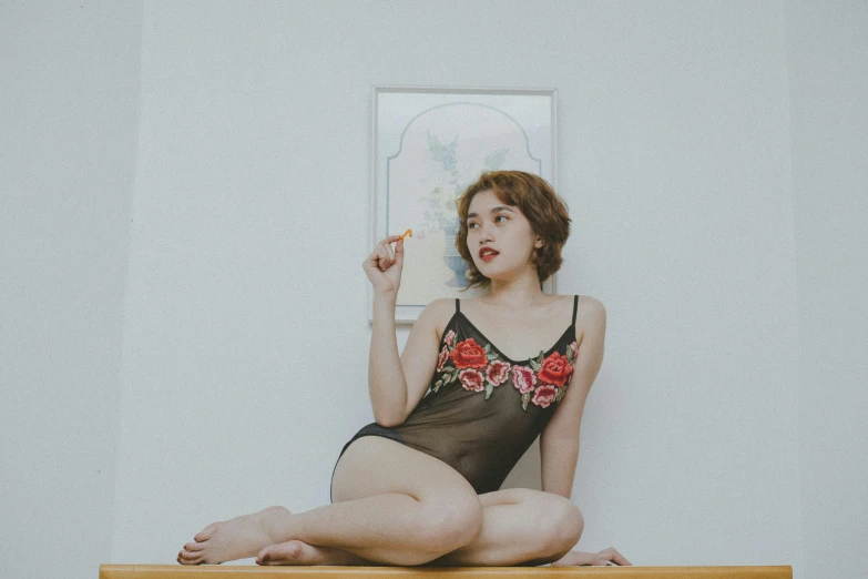 woman in underwear with cigarette on top of counter