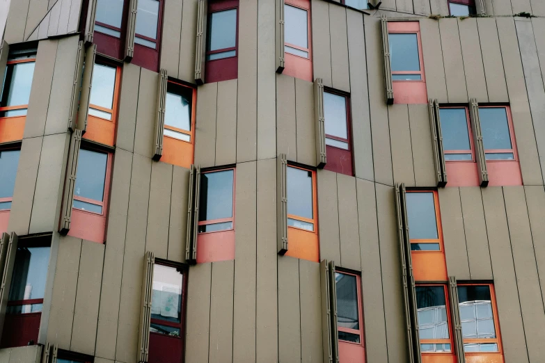 many windows on a tall building reflecting sun