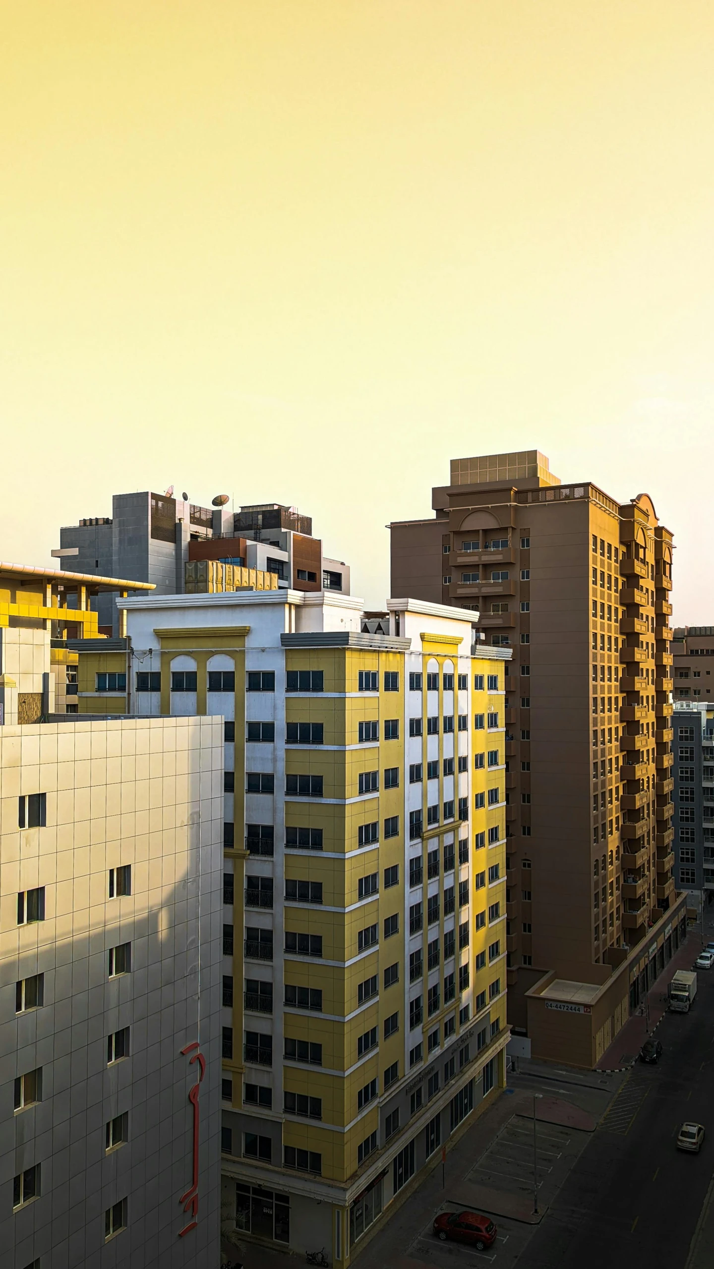 an orange and yellow building is against a sunset sky