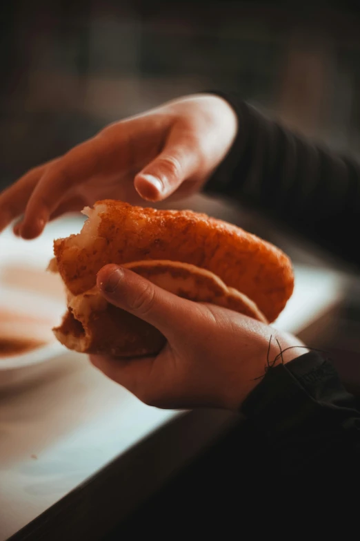 someone grabbing food from a persons hand that is reaching down into a bowl