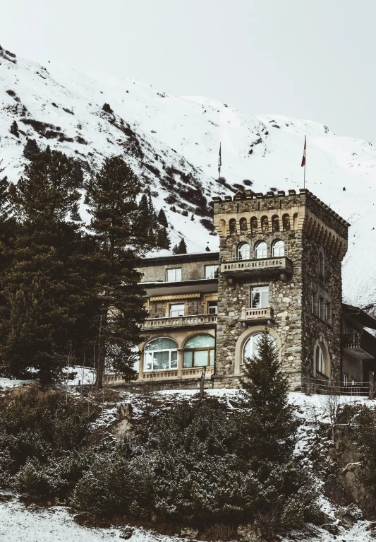 a building is surrounded by snow and trees