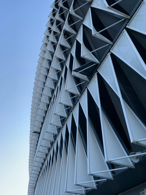 the bottom part of an office building with a sculpture in front