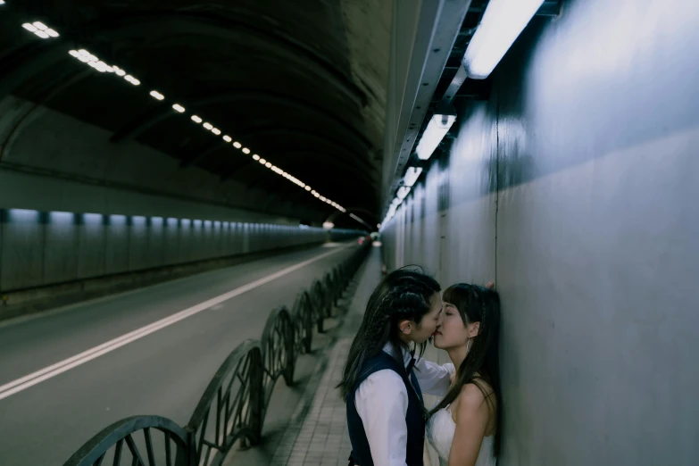 a couple kiss in a tunnel during their engagement session