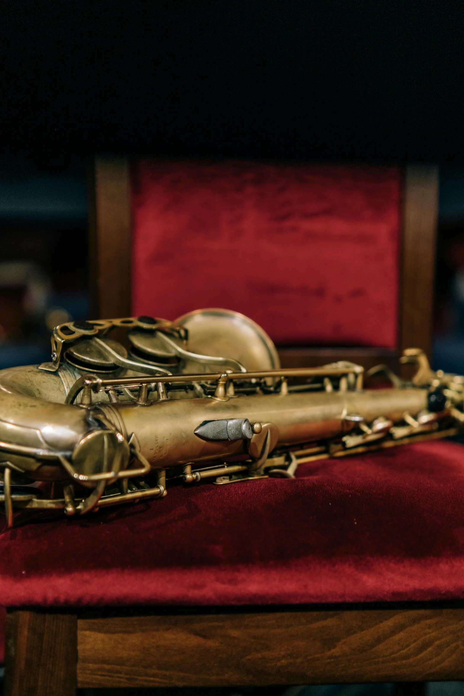 two shiny flutes sitting on a red velvet chair