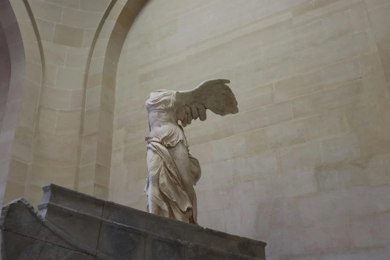 a statue sits atop a long staircase