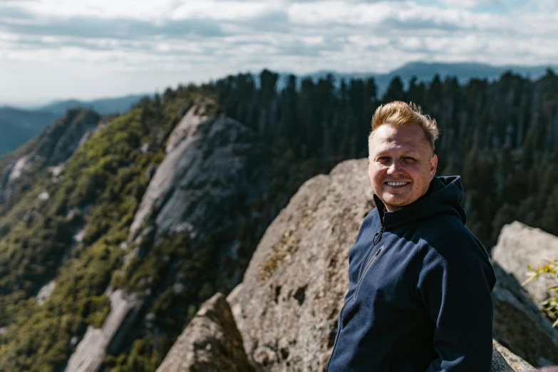 a man stands on top of the mountain